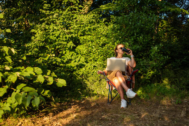 istock Young woman working with laptop in nature 1257029484