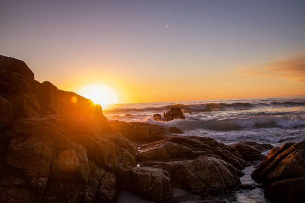 A Pacific sunset in the fall photo taken on a beach right off of 17 Mile Drive in Carmel CA.  There was some wildfire haze in the air adding to to color hues.