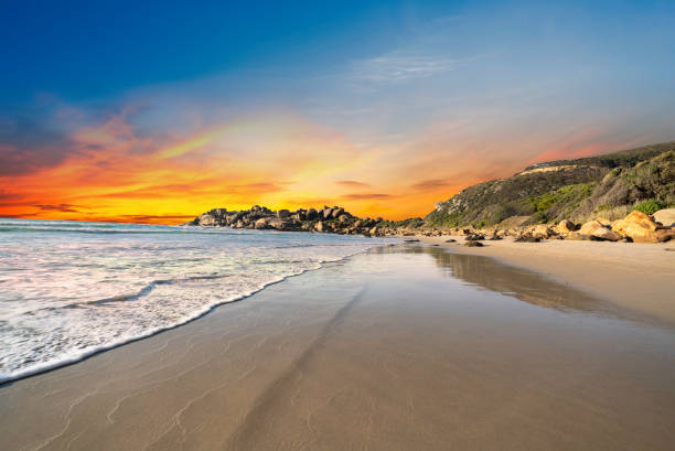 Llandudno sandy Beach at sunset  with rocks and mountain in Cape Town South Africa