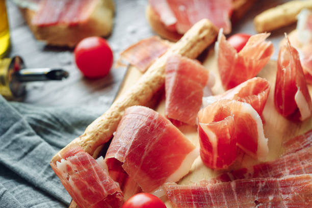 istock Ham still life cut with bread, oil and tomato 1257031841