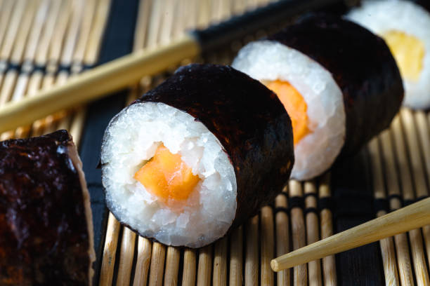 Close up Healthy traditional japanese Sushi set nigiri and rolls with chopsticks. stock photo