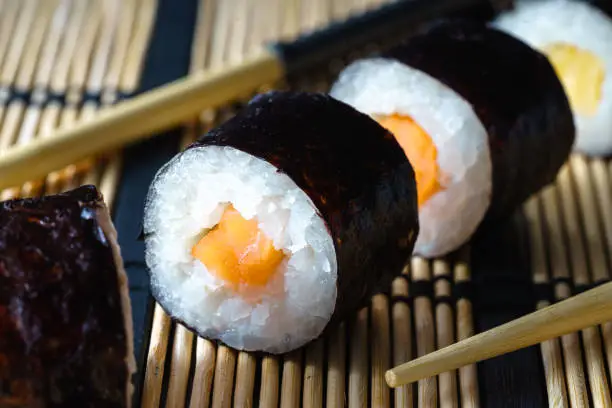Close up healthy traditional japanese Sushi set nigiri and rolls with chopsticks.