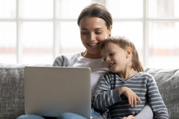 istock Happy young mother and little son using laptop together 1257033432