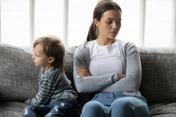 istock Offended upset young mother and little son ignoring each other 1257033436