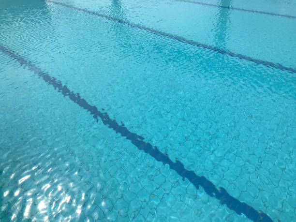istock outdoor swimming pool and Starting Platform at noon 1257033522