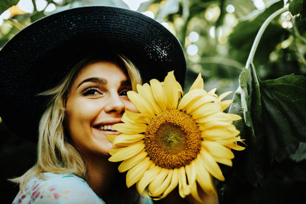 istock Happy blonde female in the sunflower fields 1257033554