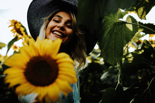 istock Happy blonde female in the sunflower fields 1257035598