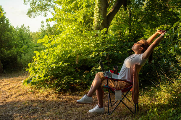 istock Young woman working with laptop in nature 1257037613