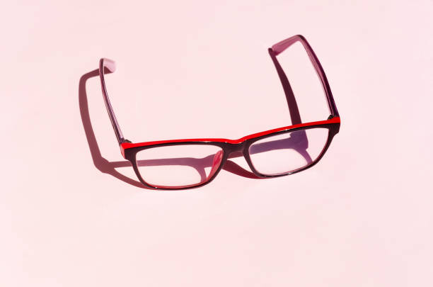 istock Eyeglass on pink background with shadows 1257039783