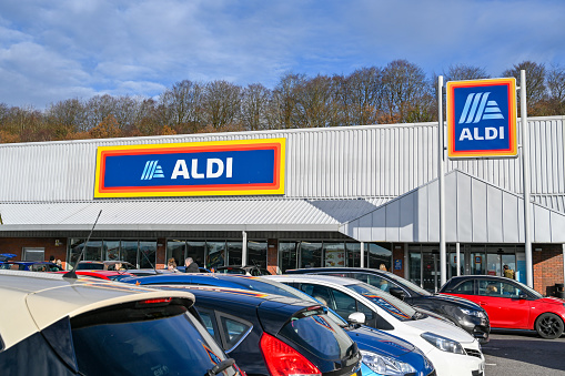 Pontypridd, Wales - December 2019: Signs on the front of the ALDI supermarket in Upper Boat near Pontyrpidd with cars parked outside.