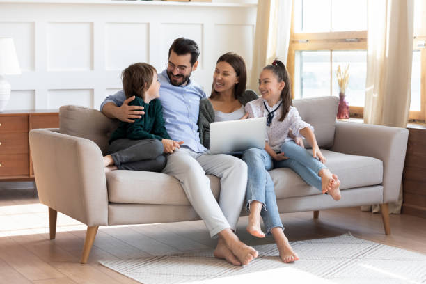 istock Happy young family enjoying leisure time with kids, using computer. 1257040836
