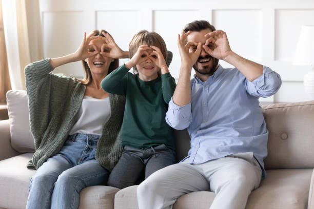 istock Overjoyed couple playing tricks fool with son at home. 1257040924