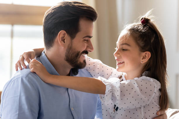istock Affectionate young daddy embracing little kid daughter. 1257040939