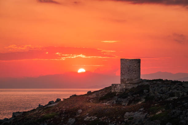 istock Sun rising behind genoese tower in Corsica 1257042114