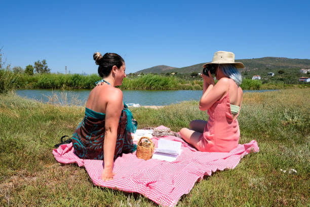 Single mom having a picnic with her daughter in nature