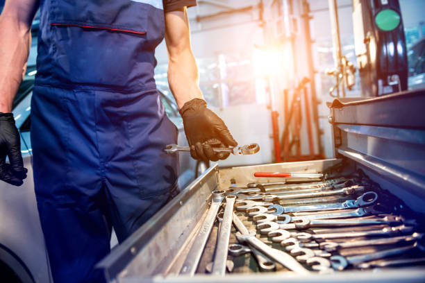 istock Tools at the hands. Auto repair service 1257042498