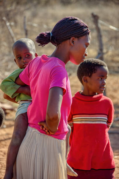 istock mother with kids standing in the yard 1257045029