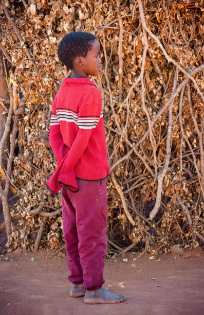 istock african child standing next to the wall 1257045751