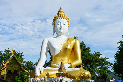 Chiang Mai, Thailand - July 7, 2020 : Large Buddha statue at Wat Phra That Doi Kham.