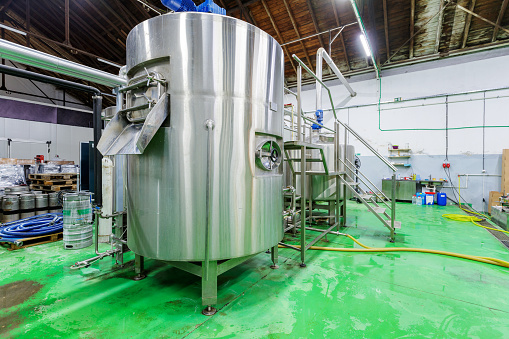 Large fermenting tank inside brewery production premises