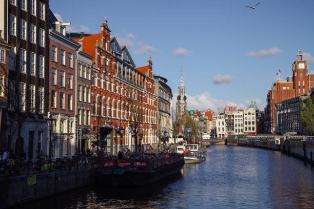 Amsterdam, Netherlands - 04 17 2016: Munttoren is a tower in Amsterdam, the Netherlands. It stands on the busy Muntplein square, where the Amstel river and the Singel canal meet.