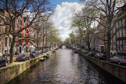 Amsterdam, Netherlands - 04 17 2016: Keizersgracht canal bridges in Amsterdam, Netherlands. Amsterdam is home to more than one hundred kilometers of canals, most of which are navigable by boat.