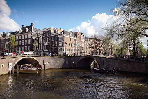 Amsterdam, Netherlands - 04 17 2016: Keizersgracht canal bridges in Amsterdam, Netherlands. Amsterdam is home to more than one hundred kilometers of canals, most of which are navigable by boat.