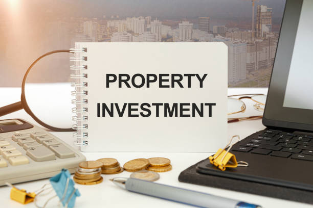 istock Workspace office desk and notebook writing Property Investment. 1257050038
