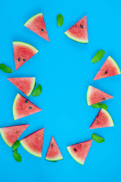 istock Top view, sliced watermelon fruit with many mints leaves on the old blue wooden table for background, wallpaper, and backdrop 1257052257
