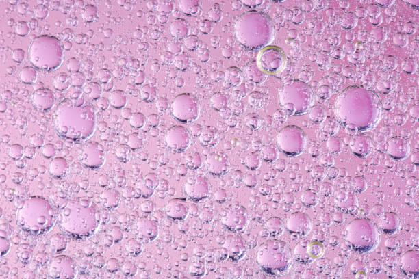 istock Abstract molecule sctructure. Water bubbles. Macro shot of air or molecule. Abstract pink and orange red background. Space or planets abstract background. Selective focus 1257052463