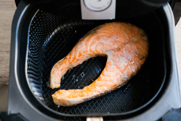 salmon steak grilled on the airfryer - prepared fish fish grilled close up imagens e fotografias de stock