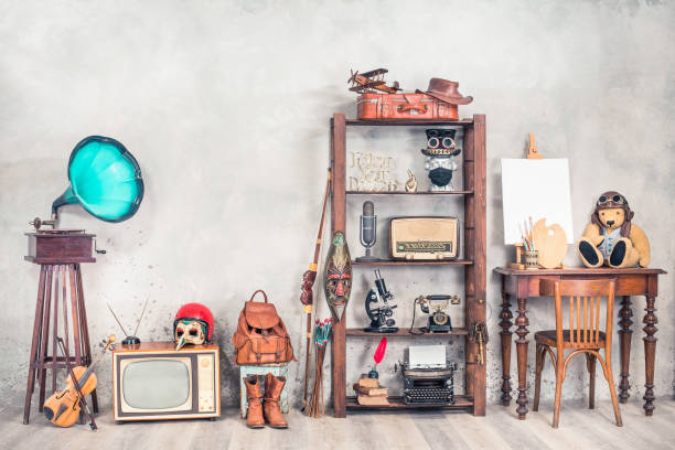 still life with antique gramophone, old teddy bear toy, collection of outdated media devices and writers tools, travel bags, easel with blank front concrete background. vintage style filtered photo - typewriter retro revival old fashioned the media imagens e fotografias de stock