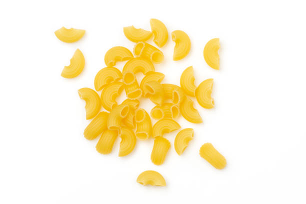 uncooked elbow macaroni isolated on white background