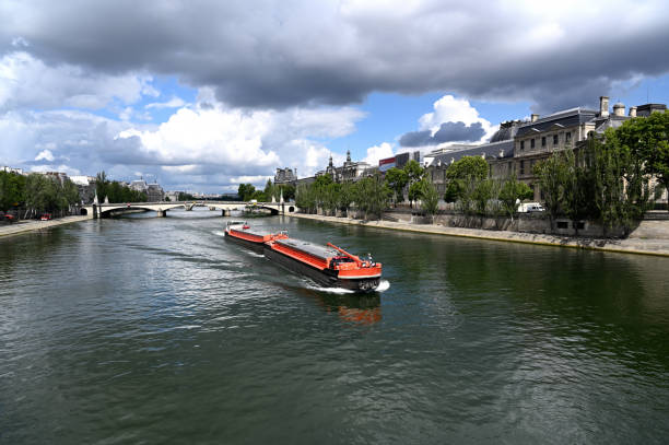 istock Long barge on the Seine river in Paris 1257056216