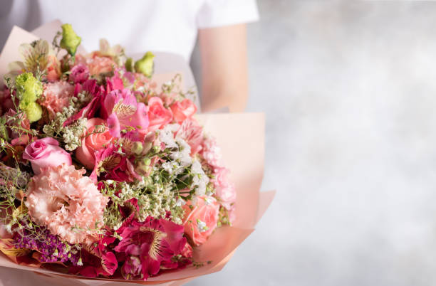 lindo buquê de flores misturadas em mãos femininas. rosas, eustomas, alstroemerias - alstromeria - fotografias e filmes do acervo