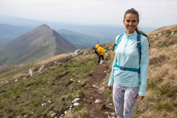 istock A young woman hiker smiling on a hiking trail 1257057521