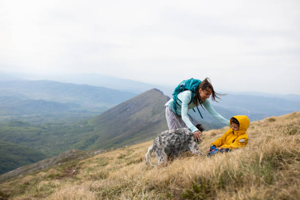 istock Mom and son hikers playing with their dog 1257057536