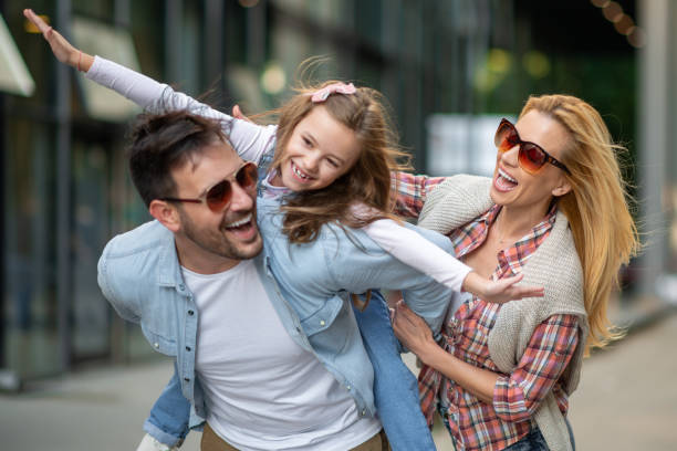 istock Happy young family of three smiling while spending time together 1257060183