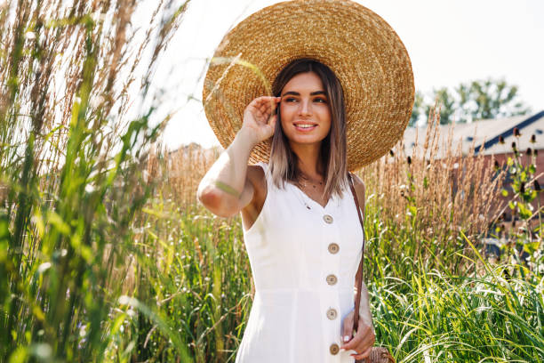 istock Young stylish woman looking away while standing on a field 1257061115