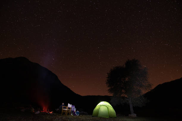 istock Friends Camping Under The Stars In Nature 1257061233