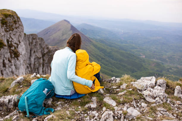 istock Mom and son hugging on a mountain top 1257061967
