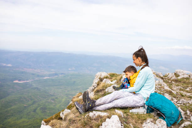 istock Mom and son resting on a mountain top 1257061968