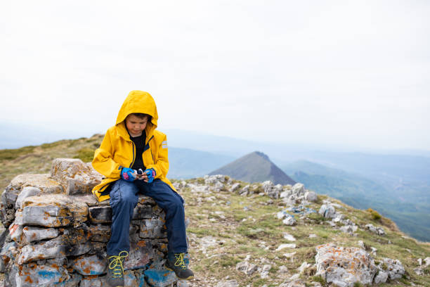 istock A boy hiker having a snack at the summit 1257062001