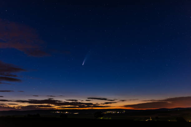 istock Comet Neowise C/2020 F3 in the blue sky with his tail and sunset 1257064108