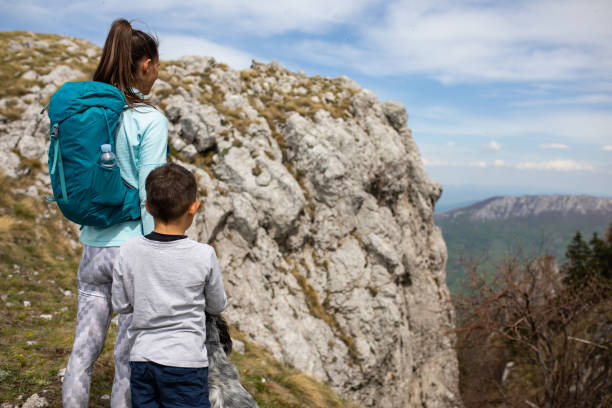 istock Mom and son hikers admiring the view 1257064222