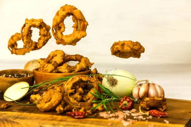 Large group of freshly fried onion rings. Homemade Crunchy Fried Onion Rings. Unhealthy food.