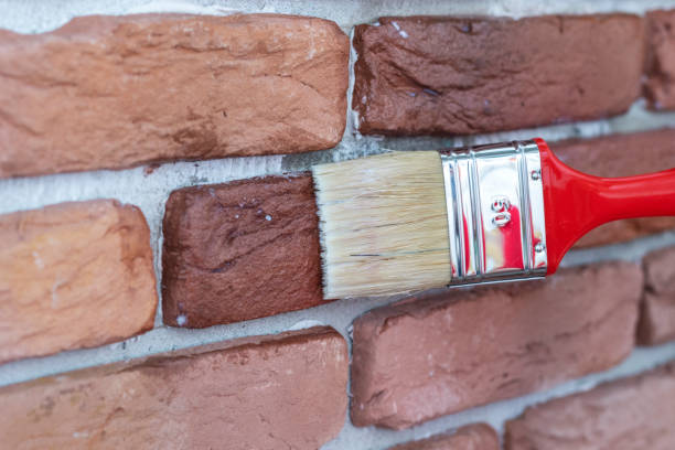 istock Covering of a decorative plaster tile with protective varnish. 1257069977