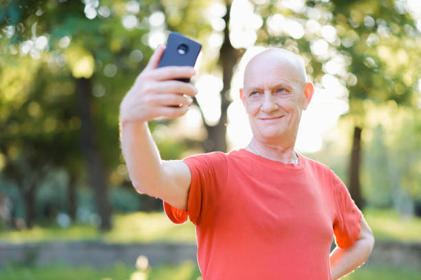 istock Man taking selfie on mobile phone in the park 1257070799