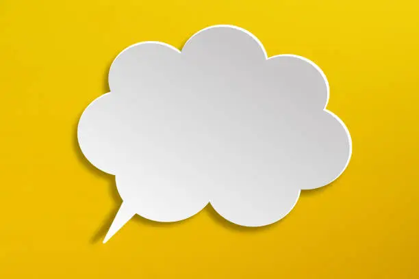 Photo of Empty white speech bubble on yellow background