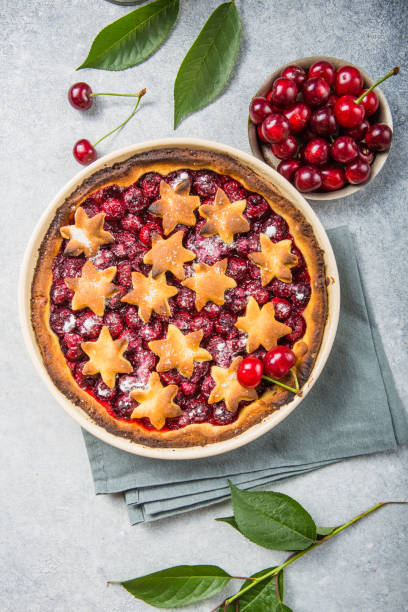 istock Homemade open cherry pie with frech cherries  on a gray concrete background. 1257072144